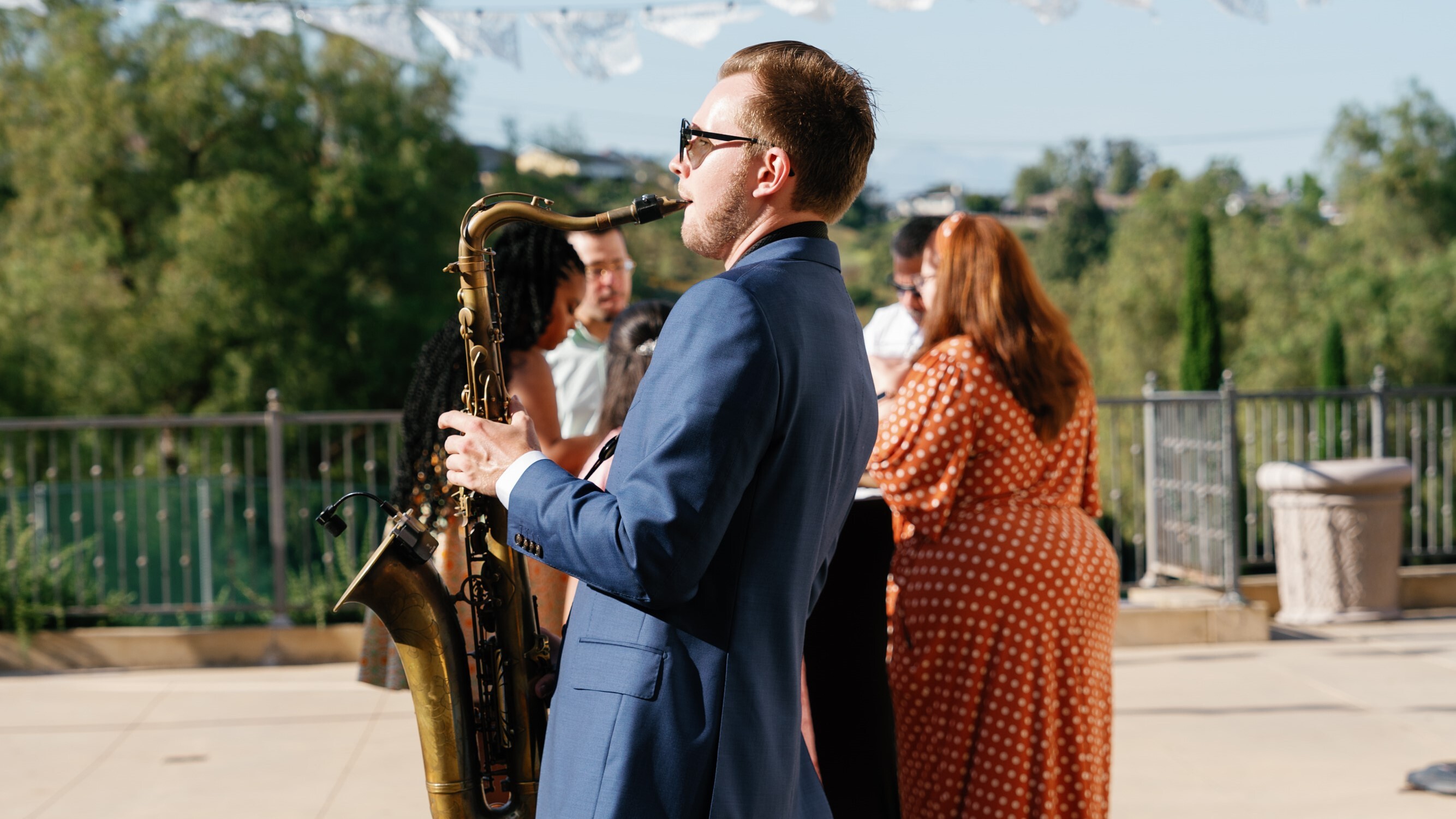 Saxophonist performing at a vibrant cocktail hour.